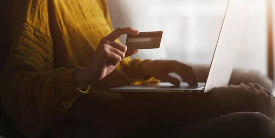 Woman online holding a credit card