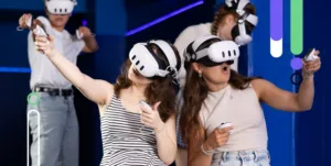 Two girls playing on VR headsets connected to a holiday park WiFi network.