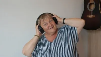 Happy older lady wearing headphones