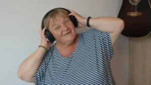 Happy older lady wearing headphones