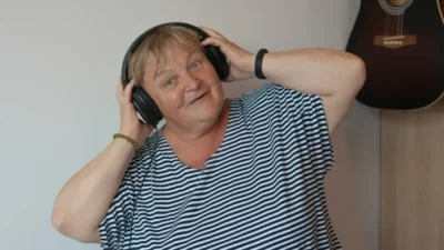 Happy older lady wearing headphones